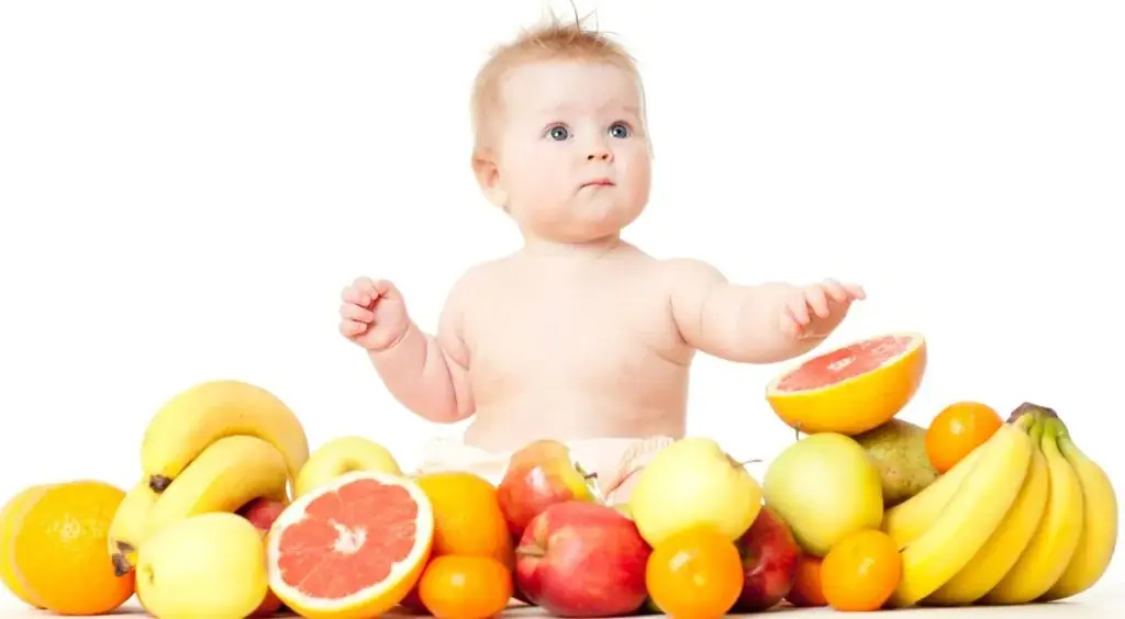 Healthy baby with fresh fruits illustrating child nutrition and growth care at Tiny Totz Kids Clinic in Puppalguda, Hyderabad