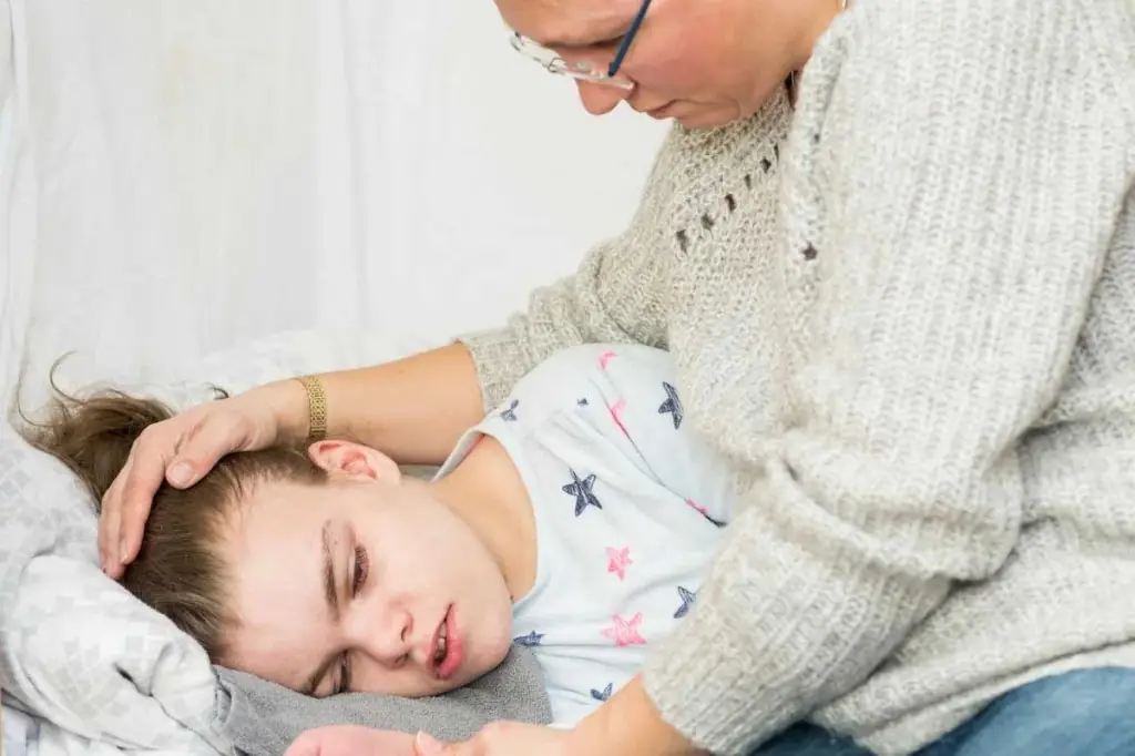 Parent comforting a child in bed after a concerning episode, seizure evaluation support at Tiny Totz Kids Clinic in Puppalguda, Hyderabad