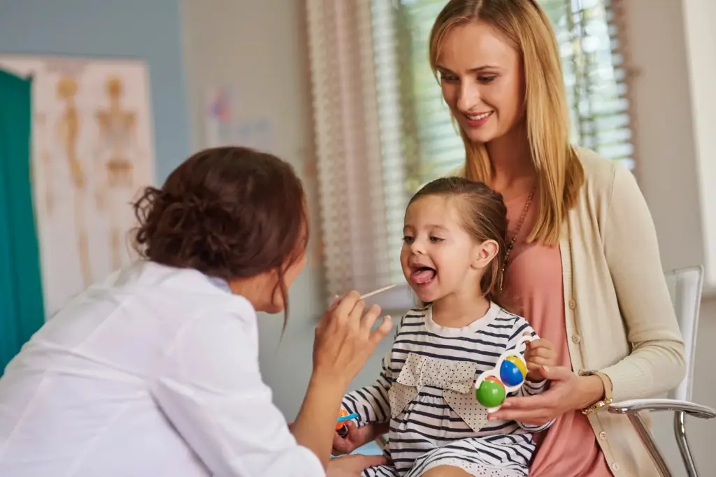 Paediatrician examining a young child’s throat during a well-child visit at Tiny Totz Kids Clinic in Puppalguda, Hyderabad
